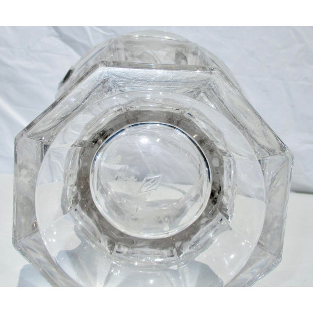 Cut Heisey Glass basket vase. Eight-sided handled basket with a floral design carved into opposing panels. Tall, elegant...