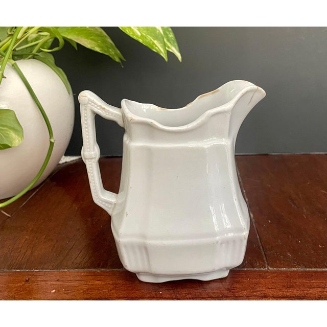 Charming antique Royal Ironstone pitcher by H. Alcock & Co of England. This small creamer/ pitcher is crafted in creamy...