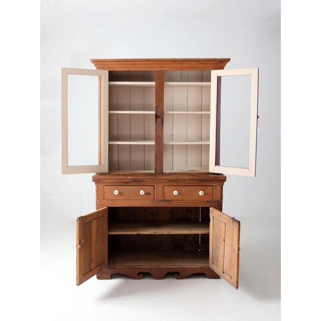 A late 19th-century American hutch cabinet with wonderful timeworn character and a warm, rustic presence. The glazed upper...