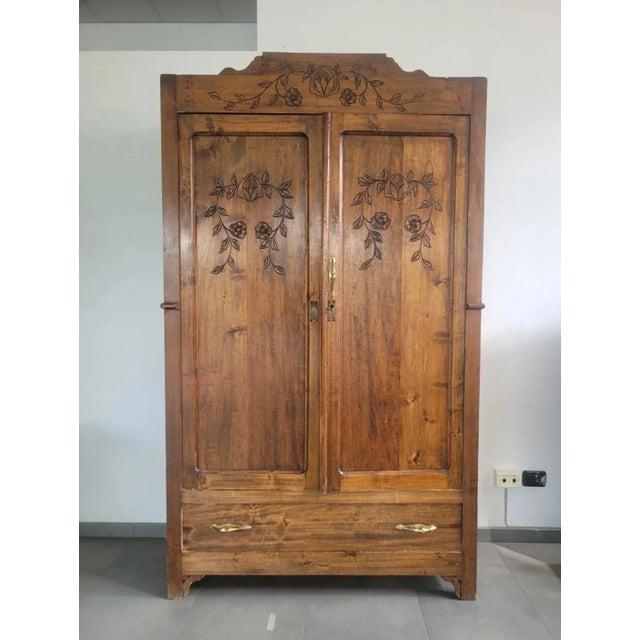 Antique two-door wardrobe in solid walnut, with carved doors and moulding. Period: First half of the 20th century. Good...