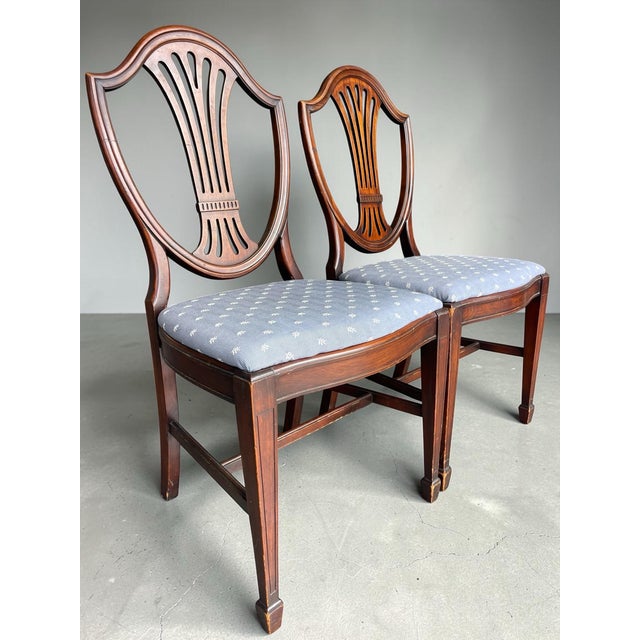 Elegant pair of vintage shield-back dining chairs by Lammert’s. Crafted in a warm mahogany finish with pierced splat backs...