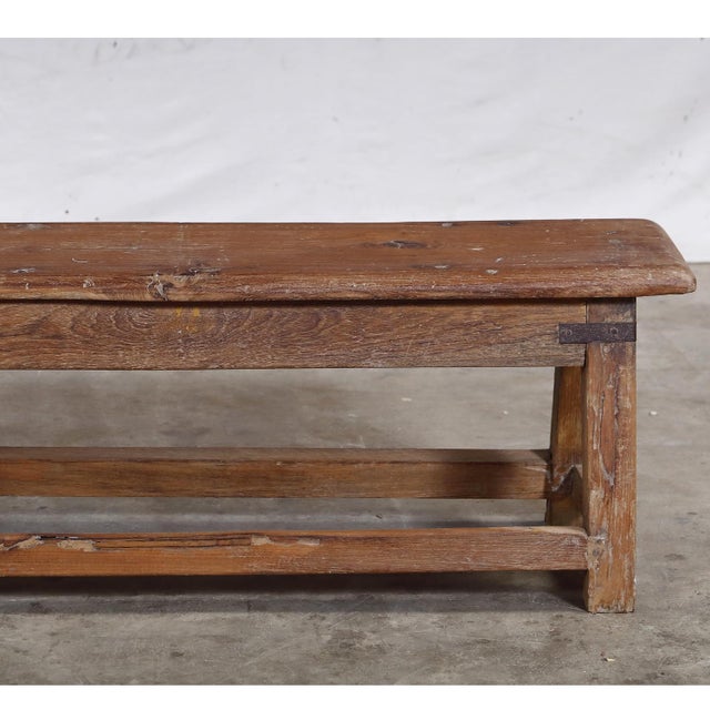 Vintage Indian Teakwood Bench, mid-century from a school or public space. It is functional and versatile with a beautiful...