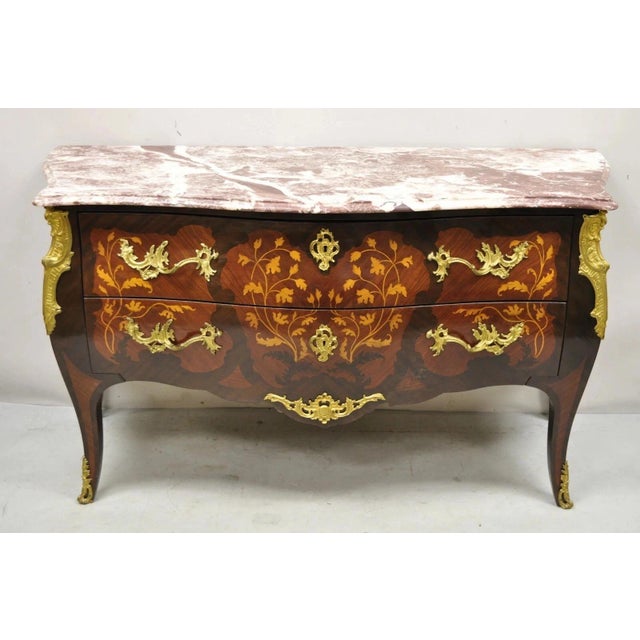 Vintage French Louis XV Style Marble Top Marquetry Inlay & Bronze Ormolu Bombe Commode Dresser. Item features ornate...