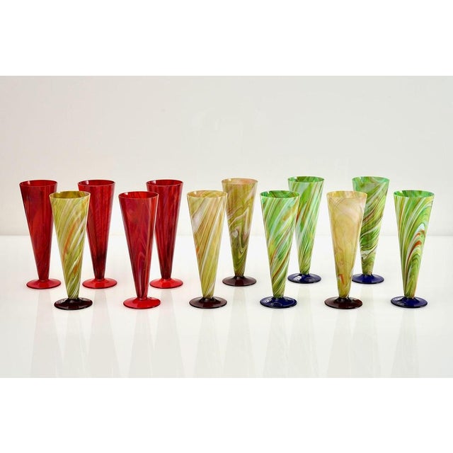 Splendid set of 12 Flute glass by Cenedese in marbelised glass and solid color foot. There are 3 basic colors, Red, Green...