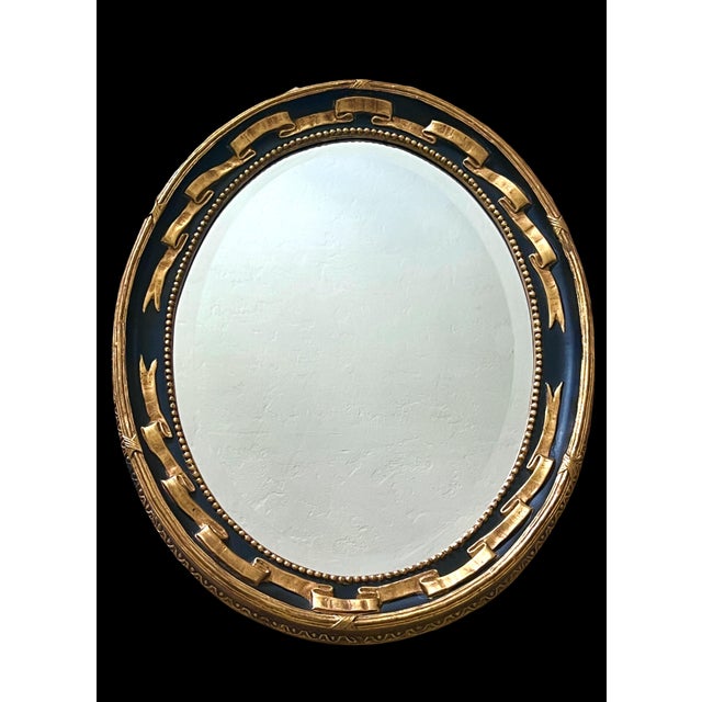 Elegant eye catching Regency style oval bevelled wall mirror by prestigious Friedman Brothers Decorative Arts Inc....