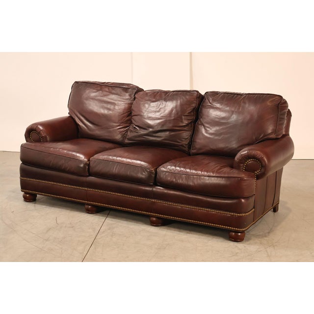 High Quality American Made Leather Three-Seat Sofa with Rolled Arms and Brass Tack Trim, Mounted on Bun Feet