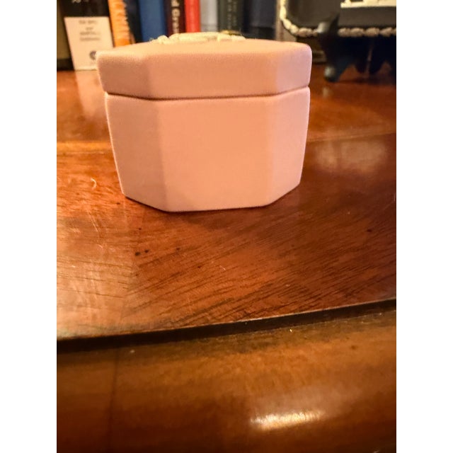 This Vintage Wedgwood Pink Jasperware Octagonal Trinket Pill Box features a charming Cupid motif, making it a lovely...