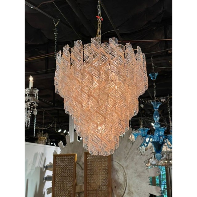 The Vintage Murano Clear and Blush Spiral Glass Waterfall Chandelier is a stunning piece of architectural lighting that...