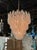 The Vintage Murano Clear and Blush Spiral Glass Waterfall Chandelier is a stunning piece of architectural lighting that...