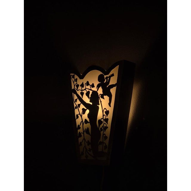 A rare wall light with decor of woman and cherub, in white metal and glass Swedish Grace 1930s. New wiring, follow swedish...