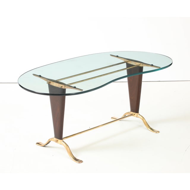 1960's mid-century modern solid brass and walnut base with kidney shape glass top coffee table in the style of Paolo...