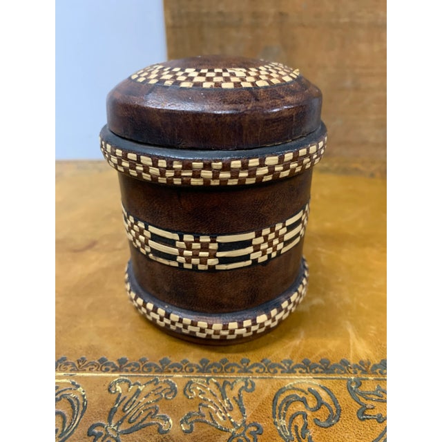 This is a pair of vintage decorated tobacco tins. English, leather bound metal cigarette canister, dating to the mid 20th...