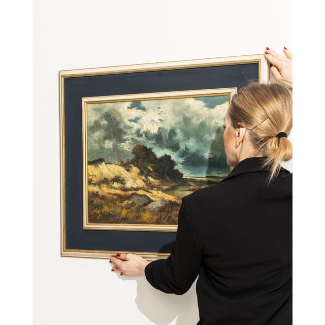 This mid 20th century painting from Belgium is an oil on canvas. It is distinguished by its stormy sky & dunes, a detail...