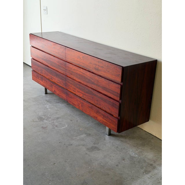 Elegant vintage Danish Mid-Century Modern dresser crafted in richly grained rosewood. This low-profile piece features...