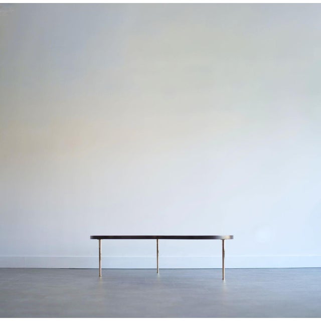 An iconic design by T.H. Robsjohn-Gibbings for Widdicomb (1950, USA), this sculpted walnut and brass Freeform cocktail...