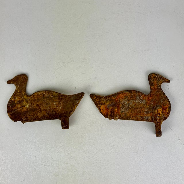 A pair of large vintage carnival/fairground metal duck shooting targets with a lovely yellowish patina. Though a somewhat...