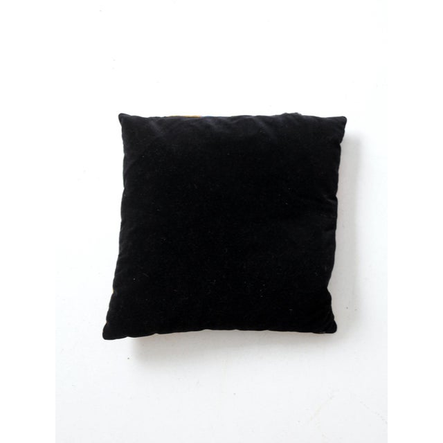 An antique Victorian crazy quilt pillow pieced from colorful velvet, silk, corduroy, and woven fabrics with hand-...