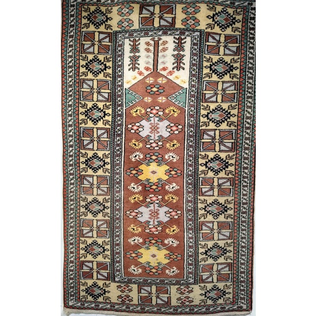 This Turkish tribal rug from the mid-1900s has the traditional “mehrab” design of the prayer carpets. Beautiful natural...