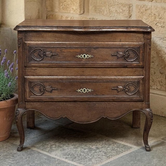 This 19th century Louis XV Country French commode captures the warmth and grace of provincial craftsmanship, rendered in...