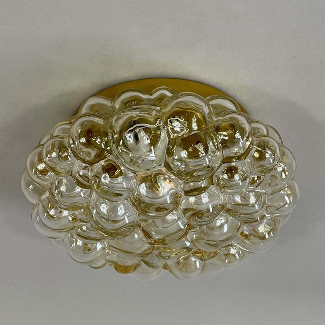 This mid-century flush mount was designed and manufactured in germany by glashütte limburg in the 1960s. The light...