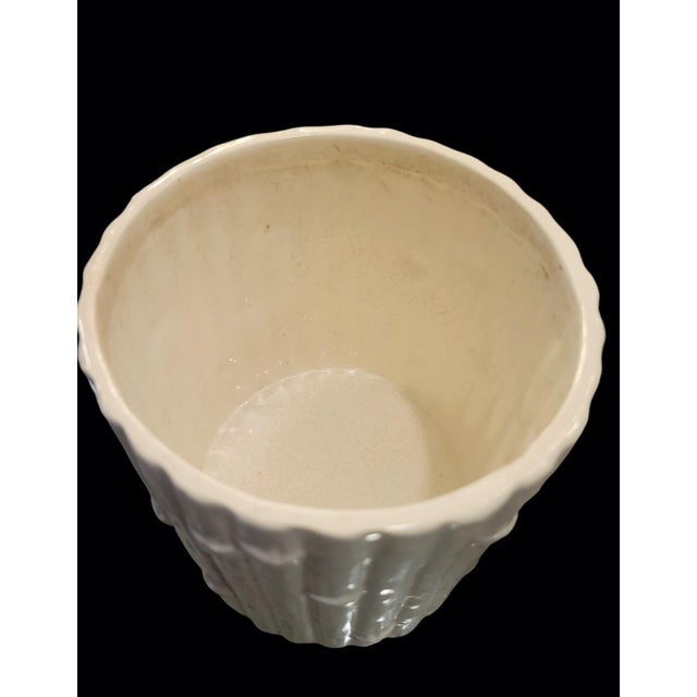 A wonderful pair of white ceramic faux bamboo planters. The planters come in 2 sizes as noted below, a small and medium...