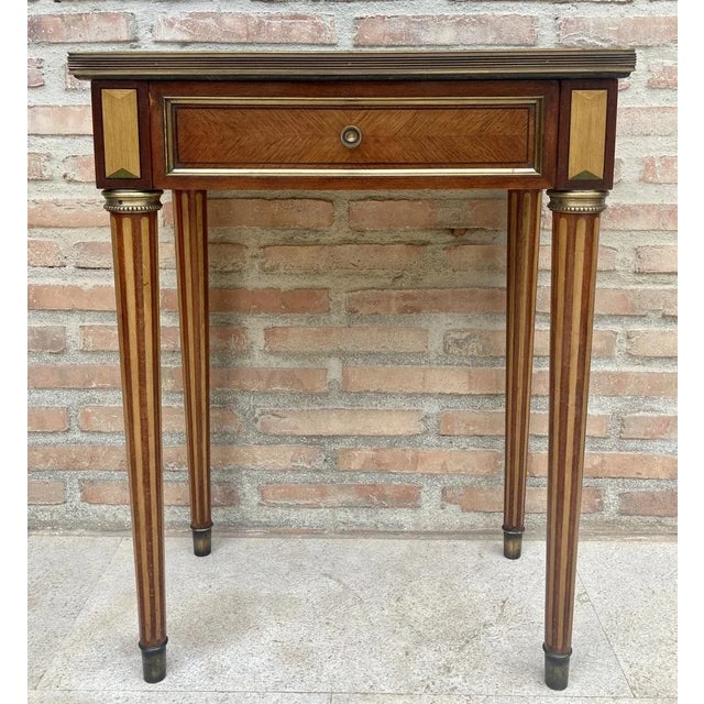 Unusual early 20th century Neoclassical Style rectangular side table with fluted legs and green and white marble. It has a...