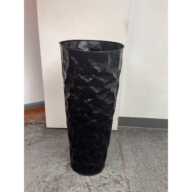 Design Plus Gallery presents a Black Hammered Planter. This planter has a tall, tapered silhouette with an allover faceted...