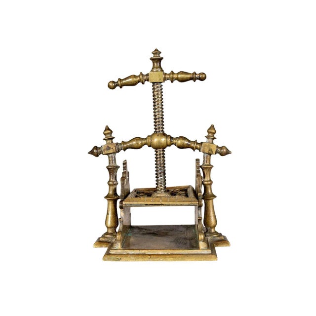 Brass playing card press with ornate details. Functional central screw mechanism.