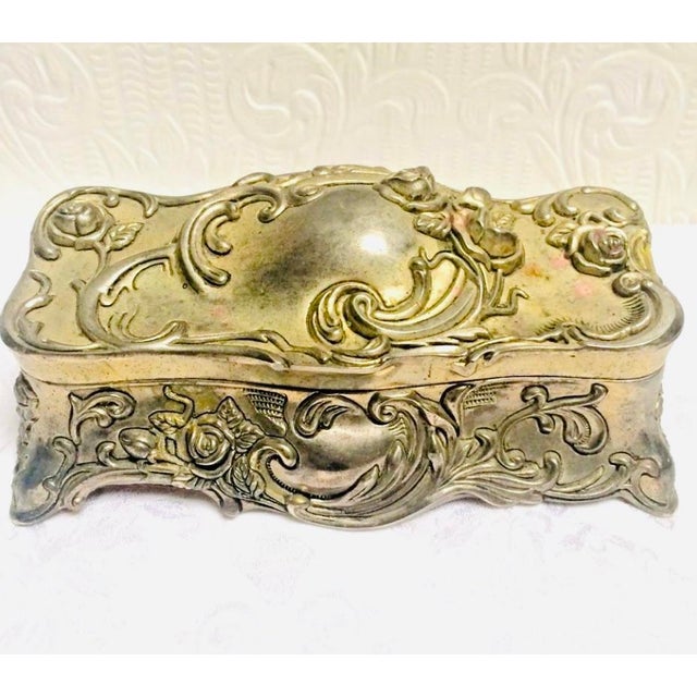 This is a beautiful silver plated Art Nouveau blown out roses box that will bring nostalgic beauty to any room.