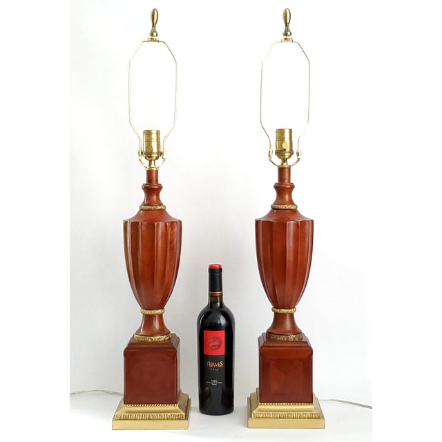Offering a pair of vintage Neoclassical solid mahogany and brass table lamps made by Bombay Co. with vintage shades...
