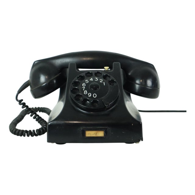 Vintage rotary-dial telephone made entirely of bakelite; designed in 1951 by ericsson for the ptt, the design is based on...