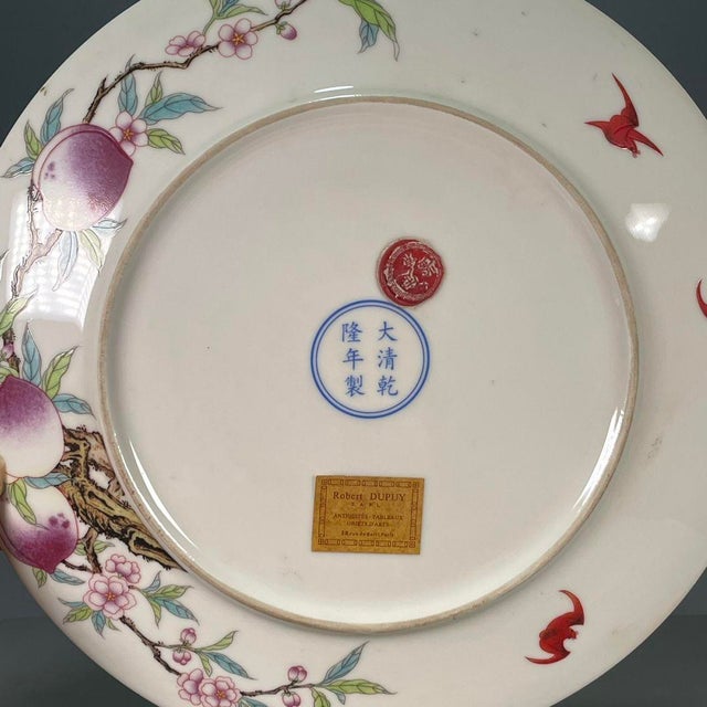 A beautiful Chinese Famille Rose porcelain charger (plate). The white ground is finely hand-painted with a classic "Nine...
