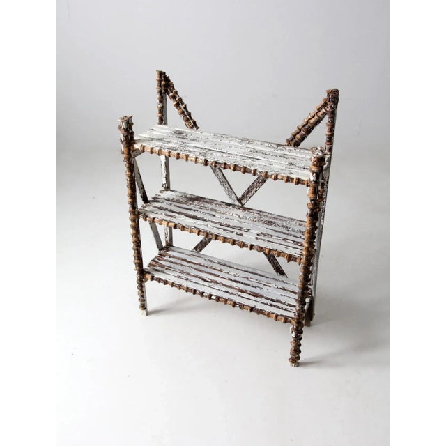 This is an antique spool art shelf. Wearing its original, now wonderfully mottled whitewash the folk art shelf features...