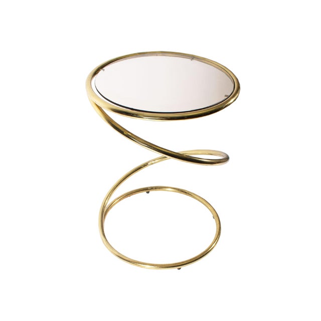 A mid-century corkscrew occasional table in the style of the Pace Collection. Unmarked, the table has a circular glass top...