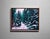 Deck the Halls captures a serene winter landscape, where snow-laden evergreens frame a tranquil path. The cool color...