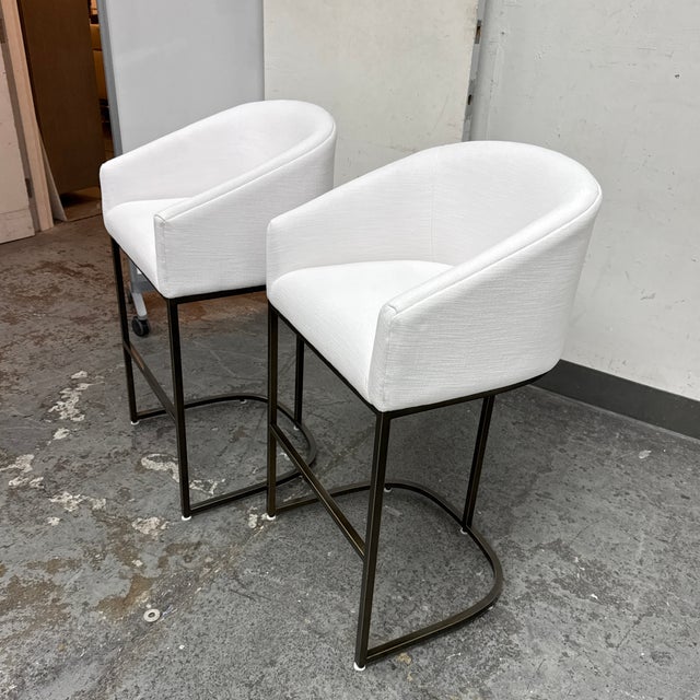 Design Plus Gallery presents a Pair of Emery Bar Stools from Restoration Hardware. The stools have a curvy handcrafted...