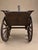 Antique cast iron horse and sulky cart featuring a sculpted horse, large spoked wheels, and a textured carriage seat. Its...