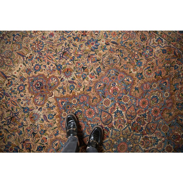 Large scale center medallion with outwardly directed floral bouquets bursting from a concentric inner medallions adored at...