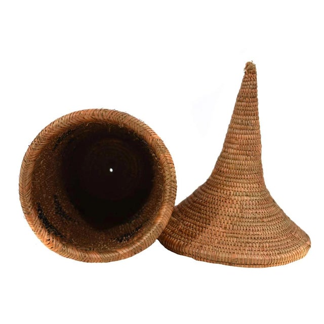 The Tutsi Tight Weave Basket with Lid from Rwanda epitomizes the artistry and tradition of the Tutsi community's weaving...