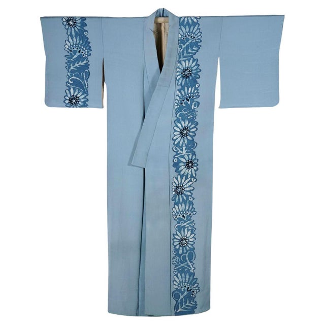 A Japanese formal silk Kimono in a light blue color with striking floral design. The garment is hand-stitched from a crepe...