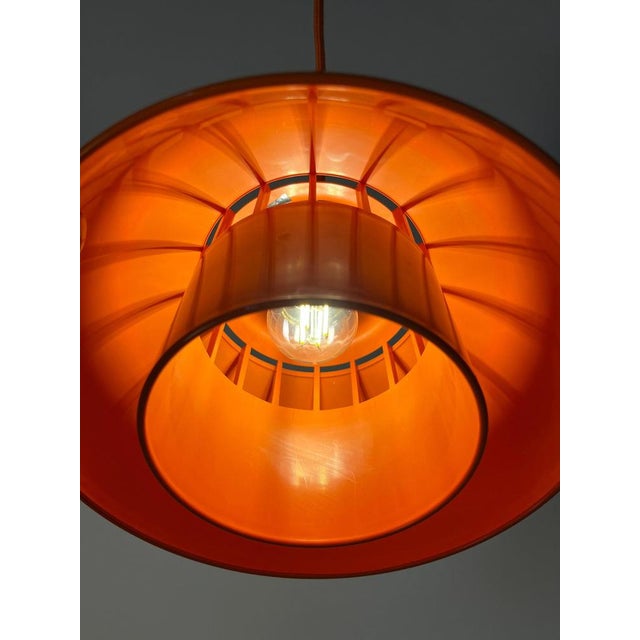 The minisol pendant lamp in vibrant orange is a true cult classic of danish design, created by k. Kewo for nordisk solar....