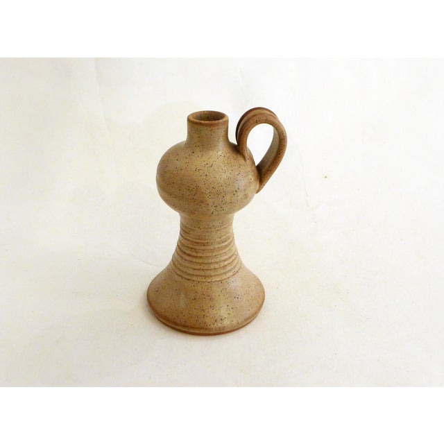 Bottle/pitcher (can be used as a single-flower vase) with a sculptural, raw shape, round base, tapered (ribbed) belly then...