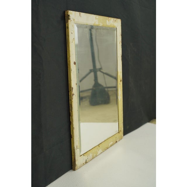 This reclaimed medicine cabinet door can be reused as a wall or accent mirror. It is made of steel with a beveled mirror....