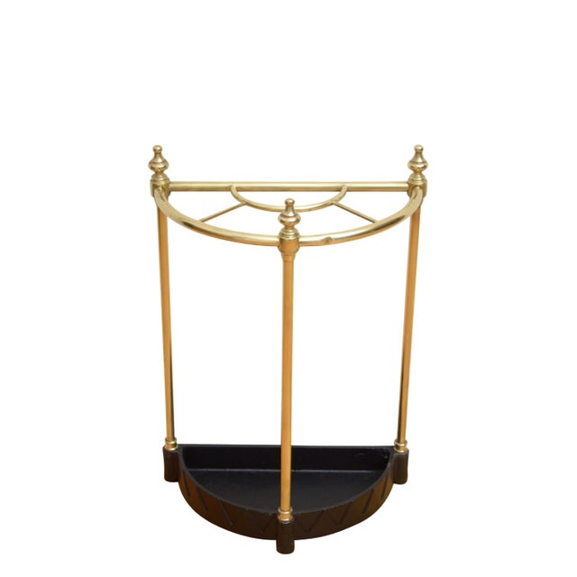 An attractive English brass demi-lune stick stand, divided into five practical sections and adorned with decorative...