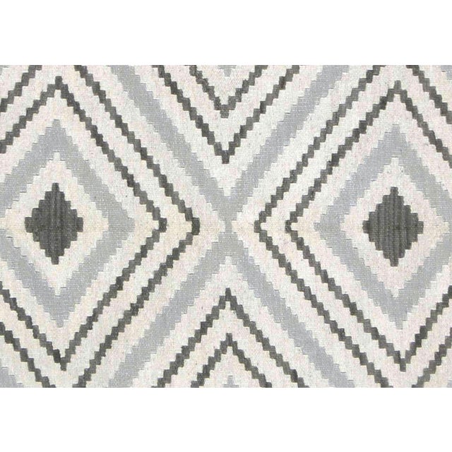 This Vintage Egyptian Kilim, measuring 6'9" x 10', is handwoven in the Fustat region of the Nile Delta using wool on a...