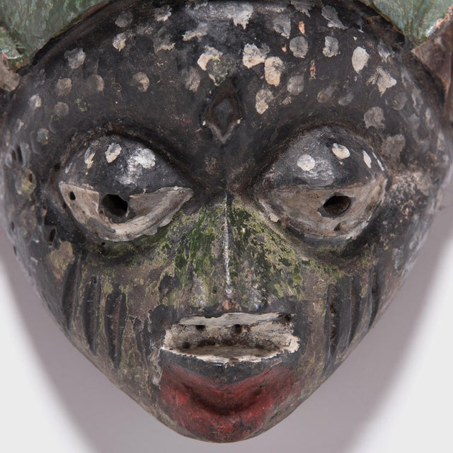 This painted mask was created by the Yoruba people of western Nigeria, and was worn during a tradition known as Gelede. A...
