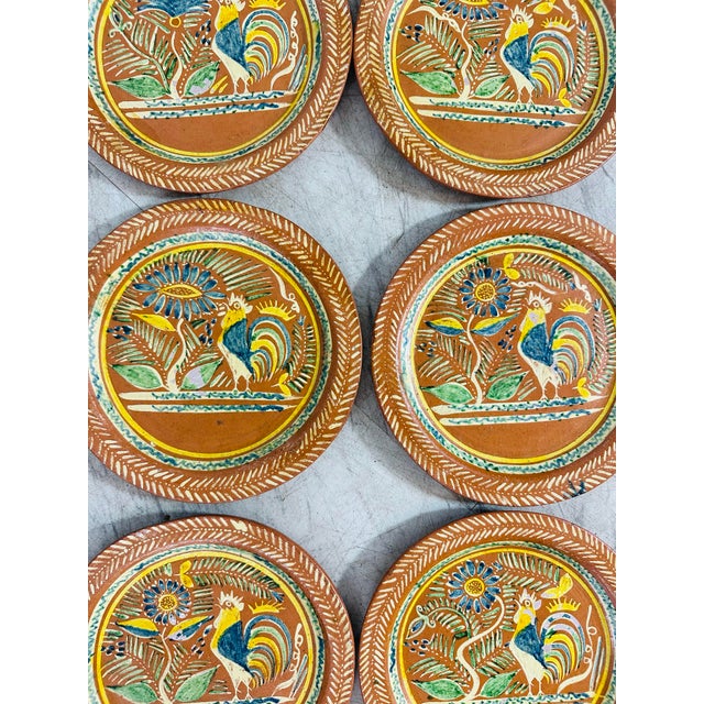Set of Six Hand-Painted Folk Art Plates Material & Finish: • These are hand-crafted, unglazed red earthenware (terracotta)...