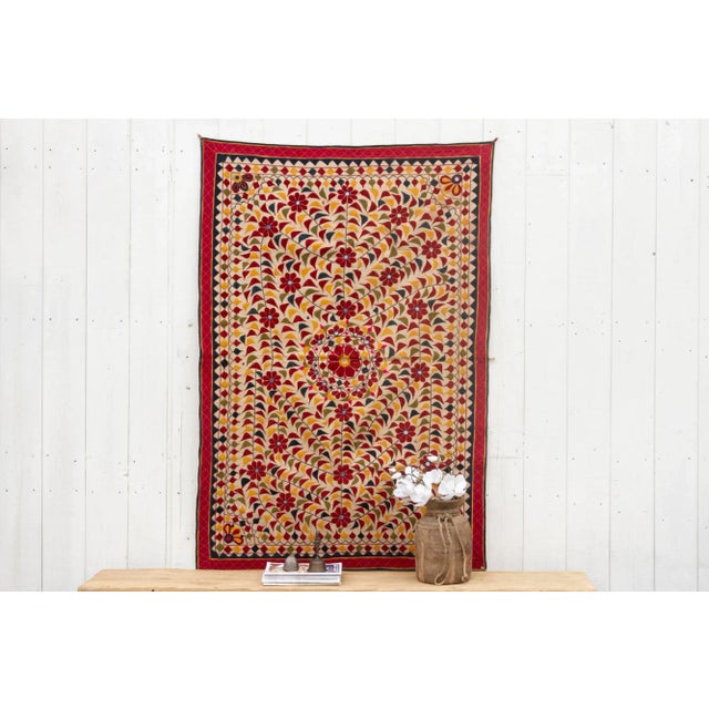 This wonderful vintage embroidered wall hanging hails directly from Gujarat, India. This exquisite piece boasts a...