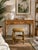 Charming vintage round ottoman featuring a natural bamboo frame with curved legs and a double-ring stretcher base. The...
