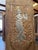A striking hand-carved wooden wall panel featuring Lord Krishna in intricate relief, surrounded by ornate floral and vine...